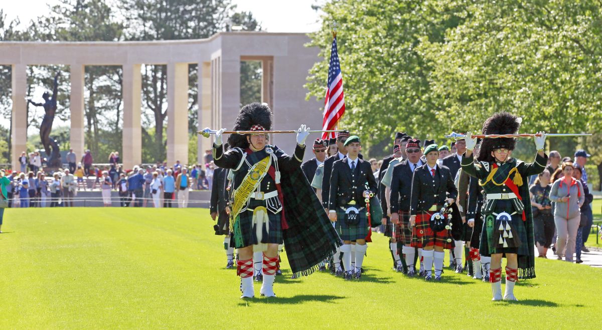 A bagpipe band performs duties at the Colleville American military cemetery in Colleville sur Mer, western France, Saturday as part of the commemoration of the 71st anniversary of the D-Day landing. (Associated Press)