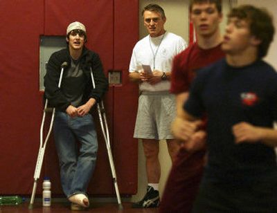 
U- Hi's Chase Fish talks with head wrestling coach Don Owen during a recent practice. Fish, a senior, who was one of the favorites to win state this year, broke his ankle wrestling. 
 (Liz Kishimoto / The Spokesman-Review)