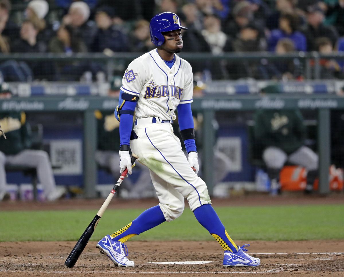 The Mariners’ Dee Gordon reacts after swinging and missing against the Oakland Athletics in the fifth inning Sunday, April 15, 2018, in Seattle. (Elaine Thompson / Associated Press)