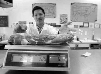 
A pork sparerib is weighed at a store in Pacifica, Calif., on Friday. Record high corn prices are driving up the price of meat nationwide. 
 (Associated Press / The Spokesman-Review)