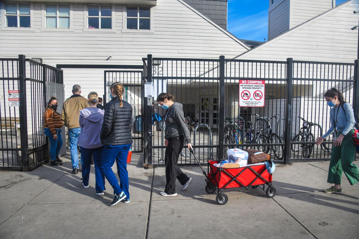 A medical team with members from Gonzaga University, Washington State University nursing schools, Medical Reserve Corps and the Spokane Regional Health District, wheel in Moderna COVID-19 vaccination supplies to the House of Charity to give the second dose to HOC clients on March 2, 2021, in downtown Spokane. Spokane Mayor Nadine Woodward announced on Monday, April 27, 2022, that the House of Charity plans to move its shelter to a new facility outside of downtown Spokane.  (DAN PELLE/THE SPOKESMAN-REVIEW)