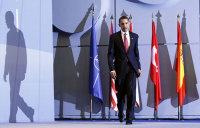 President Barack Obama casts a long shadow as he walks on stage for his news conference in Strasbourg, France, on Saturday.  (Associated Press / The Spokesman-Review)