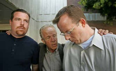 
Bob Thatcher, right, and his brother, Tom Thatcher, left, are hugged by attorney Jeff Anderson after a verdict Wednesday in a Hayward, Calif., courtroom.
 (Associated Press / The Spokesman-Review)