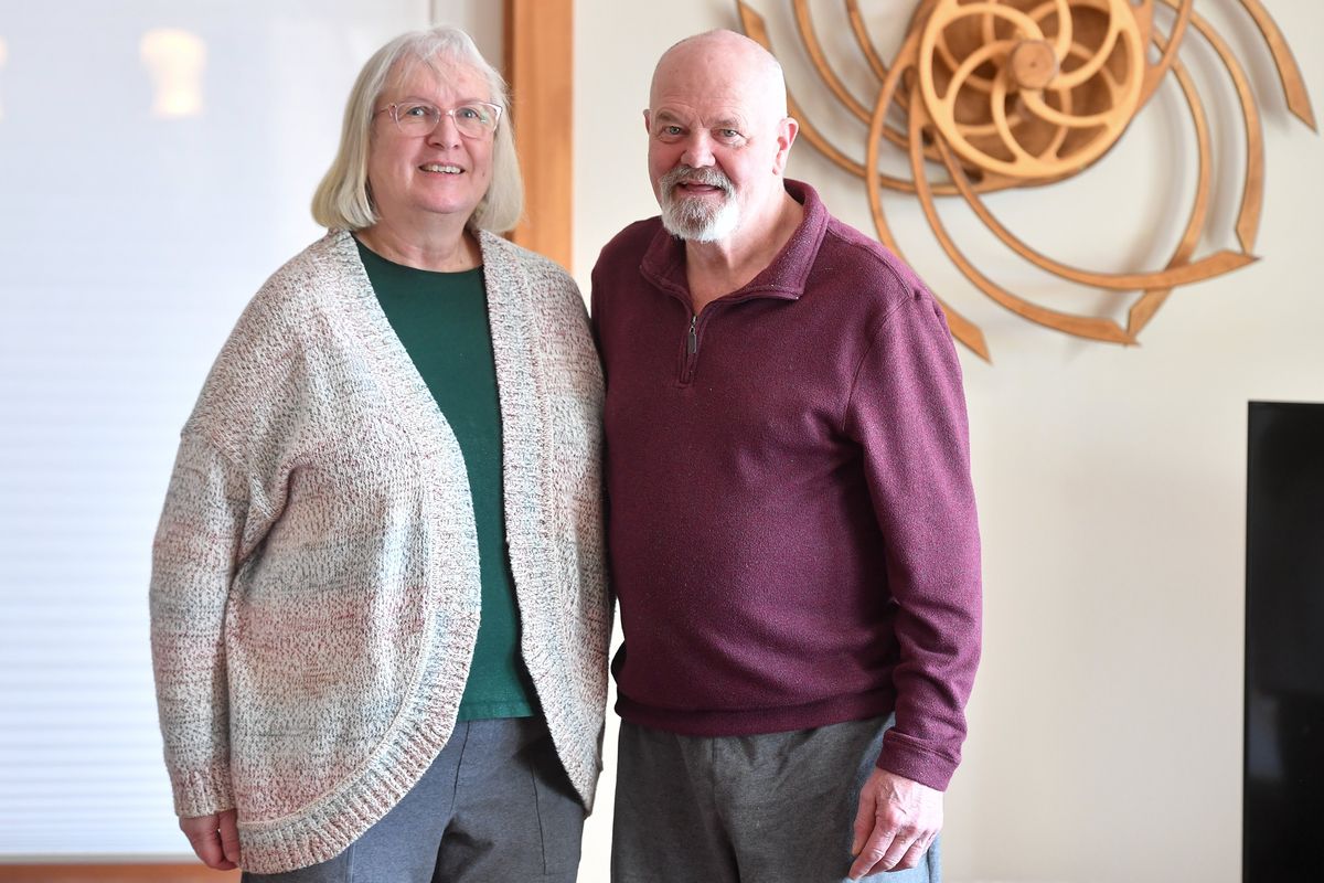Bill Meyer and his wife, Nadean Meyer, pose for a photo in their living room on Tuesday. After his Parkinson’s diagnosis, Bill was determined to keep hiking. He and Nadean created PasstoPass, offering backpacking trips for Parkinson’s-affected hikers.  (Tyler Tjomsland/The Spokesman-Review)