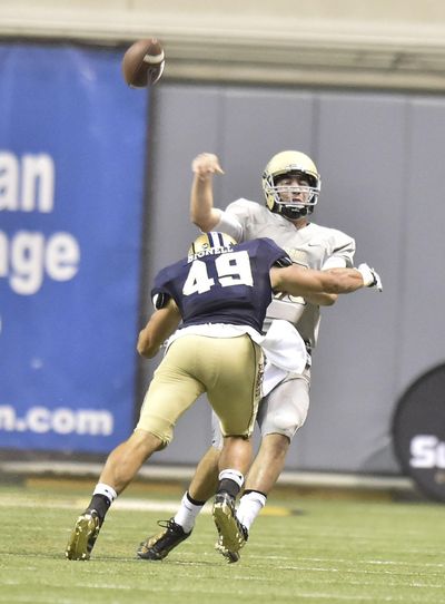 Idaho quarterback Matt Linehan, taking a hit from Montana State linebacker Mac Bignell in the season opener, guarantees his passing numbers will improve against the Huskies on Saturday. (Tyler Tjomsland / The Spokesman-Review)