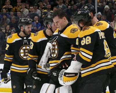 Boston Bruins goaltender Tuukka Rask (40) is helped off the ice after taking a hit on a goal by New York Rangers center Filip Chytil during the first period of an NHL hockey game, Saturday, Jan. 19, 2019, in Boston. (Mary Schwalm / Associated Press)