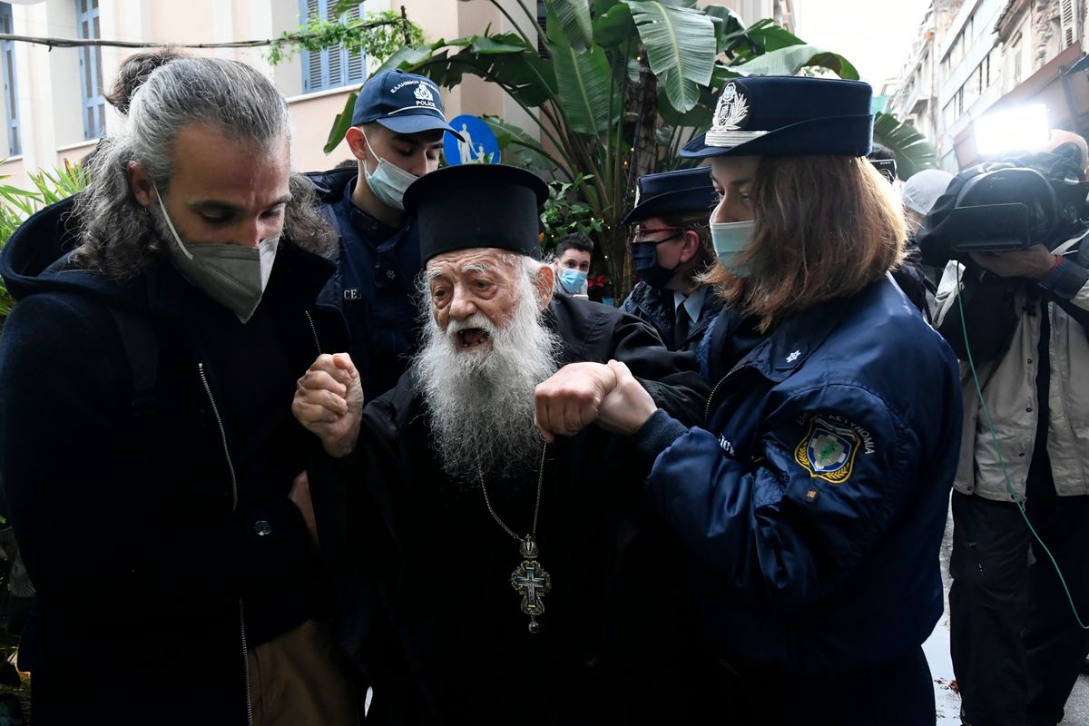 Police hold a protesting Orthodox Priest during the visit of Pope Francis at the Archbishopric of Greece in Athens, Saturday, Dec. 4, 2021. Pope Francis warned Saturday that the "easy answers" of populism and authoritarianism threaten democracy in Europe and called for fresh dedication to promoting the common good.  (Michael Varaklas)