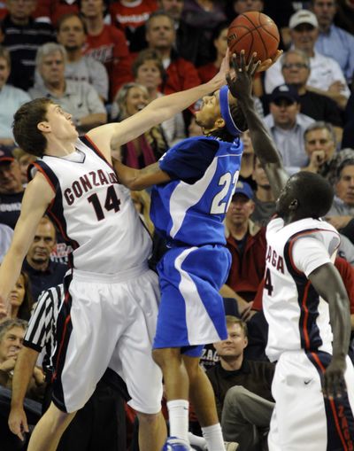 Gonzaga's Andy Poling slaps away the shot of IPFW's Jeremy Mixon in the second half at McCarthy Athletic Center Friday. (Colin Mulvany / The Spokesman-Review)
