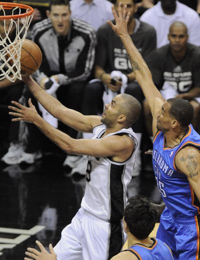 Spurs guard Tony Parker gets by Oklahoma City’s Thabo Sefolosha for two of his 22 points. (Associated Press)