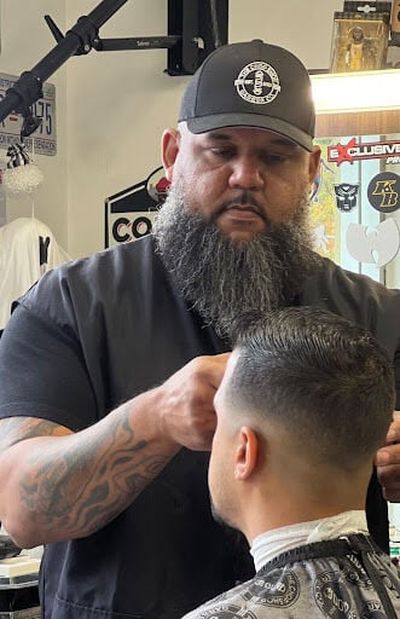 “Big Lee” Lewis cuts hair at the Chop Shop, 1428 S. Lincoln St. He and Michael Bethely have launched a podcast.  (Courtesy)