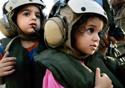 
American children wait to board helicopters to be evacuated Tuesday from the grounds of the U.S. Embassy in Beirut, Lebanon. 
 (Associated Press / The Spokesman-Review)
