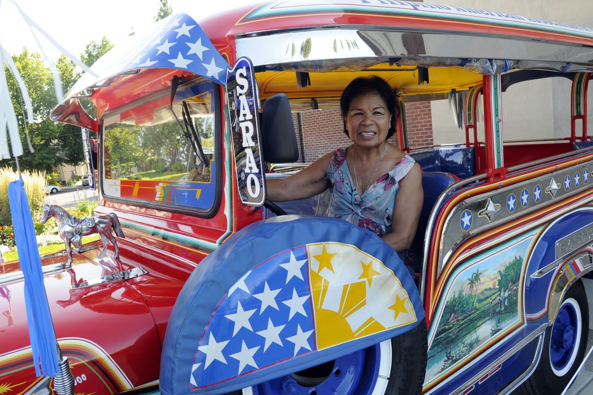 bartr@spokesman.com Norma Gavin, president of the Filipino American Association of the Inland Empire, and her husband, Mike, place a hood ornament on the jeepney the association recently imported  from the Philippines. (J. BART RAYNIAK / The Spokesman-Review)