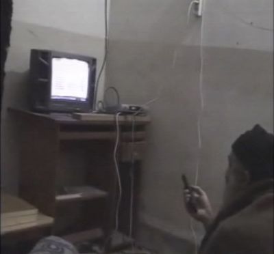 In this undated image taken from video provided by the U.S. Department of Defense, a man who the American government says is Osama bin Laden watches television in a video released on Saturday, May 7, 2011. The videos show bin Laden watching himself on television and rehearsing for terrorist videos. (Department Of Defense)