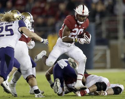 In this Nov. 10, 2017 photo, Stanford’s Bryce Love (20) runs against Washington during the first half of an NCAA football game in Stanford, Calif. (Marcio Jose Sanchez / Associated Press)