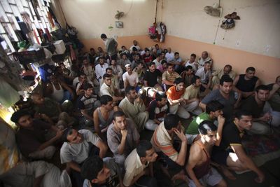 Prisoners sit in a crowded jail cell June 16 in central Baghdad. The current Iraqi leadership, charged with running the nation’s system of jails, came to power with the promise to respect human rights.  (Associated Press / The Spokesman-Review)