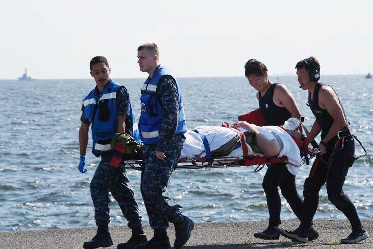 In this photo released by Japan’s Defense Ministry, an injured USS Fitzgerald personnel is carried by U.S. military personnel, left, and Japanese Maritime Self-Defense Force members upon arriving to the U.S. Naval base in Yokosuka, southwest of Tokyo, after the U.S. destroyer collided with the Philippine-registered container ship ACX Crystal in the waters off the Izu Peninsula Saturday, June 17, 2017. Seven Navy sailors were missing and at least two, including the captain, were injured after the collision off the coast of Japan before dawn Saturday, the U.S. Navy and Japanese coast guard reported. (Japan’s Defense Ministry)