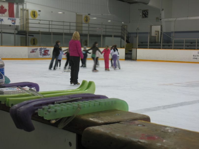 A local group of young figure skaters practices a routine for the opening ceremonies of the 2010 U.S. Figure Skating Championships as assistant choreographer Tera Caldera watches on at Eagles Ice Arena.