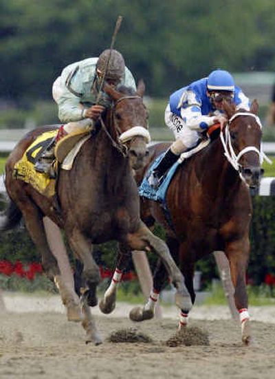 
Birdstone, left, with Edgar Prado aboard, leads Smarty Jones and jockey Stewart Elliott as they head toward the finish line. 
 (Associated Press / The Spokesman-Review)
