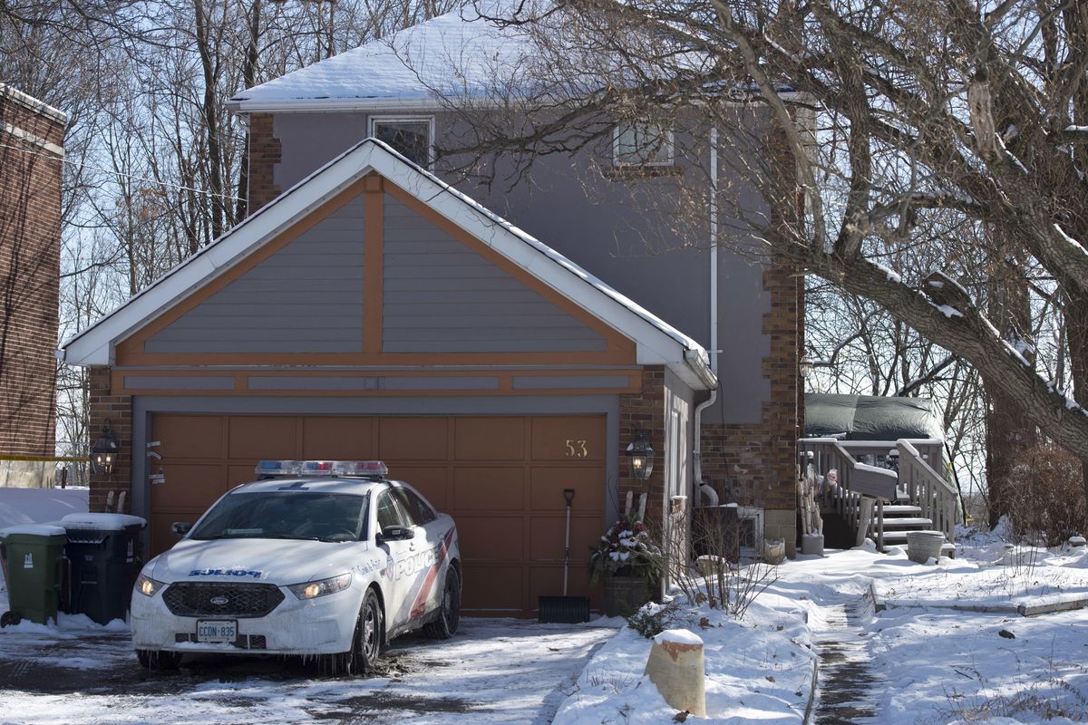 This photo taken Jan. 30, 2018, shows police guarding at a house on Mallory Crescent in Toronto. (Frank Gunn / Associated Press)