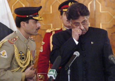 
Pakistan's President Pervez Musharraf, right, wipes his eye after he was sworn in as the country's civilian president.
 (The Spokesman-Review)