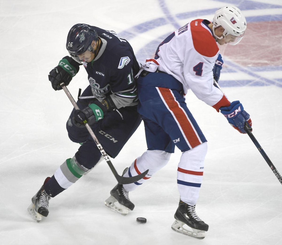 Spokane’s Jeff Faith, right, loses track of the puck in transition and Seattle’s Alexander True, left, slips behind to pick Faith’s pocket in the first period of play Sunday, Jan. 8, 2017, at the Spokane Arena. (Jesse Tinsley / The Spokesman-Review)