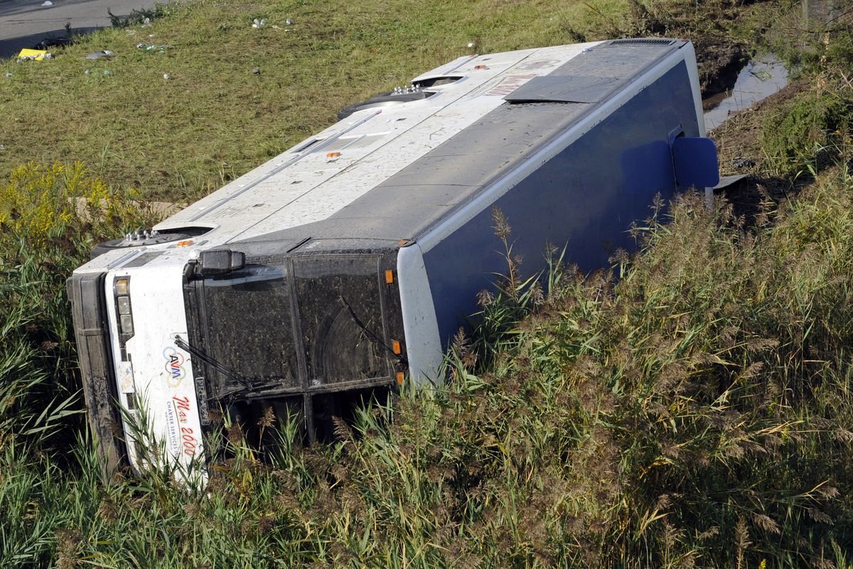 A bus sits in a ditch after it overturned coming off an exit ramp on Route 80 in Wayne, N.J. Saturday, Oct. 6, 2012. The chartered tour bus from Toronto carrying about 60 people overturned on an interstate exit ramp. Three people have been taken to hospital with non-life-threatening injuries. (Bill Kostroun / Fr51951 Ap)