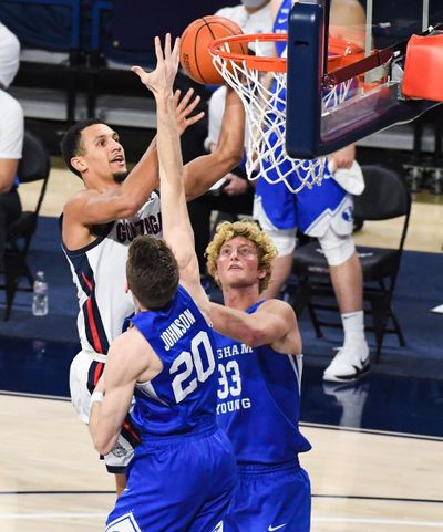 Gonzaga guard Jalen Suggs drives to the basket as Brigham Young’s Spencer Johnson and Caleb Lohner defend on Thursday night.  (Colin Mulvany/THE SPOKESMAN-REVIEW)