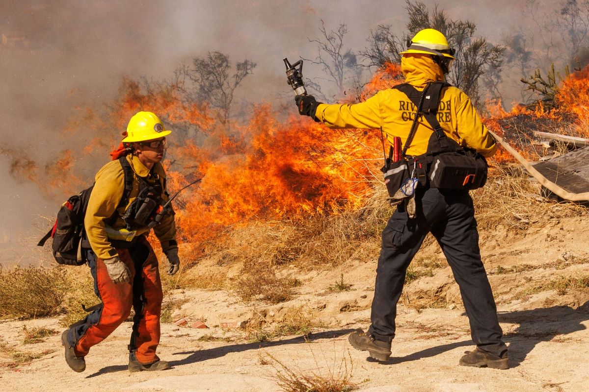 Firefighters battle the Highland Fire in Aguanga, Calif,. in October.  (Ethan Swope/Bloomberg)