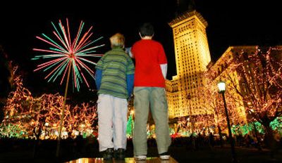 
Josh Bruno, left, and his friend Ryan Snell enjoy the Christmas lighting display recently at Public Square in Cleveland. 
 (AP/The Plain Dealer, John Kuntz / The Spokesman-Review)