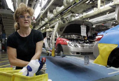 
Vedra Miracle reaches for a bolt Friday as she puts bumpers on Toyota cars moving along an assembly line at the Toyota plant in Georgetown, Ky. Toyota has led the way for Asian automakers that have steadily increased U.S. sales, and Toyota now has about 13 percent of U.S. vehicle sales. 
 (Associated Press / The Spokesman-Review)