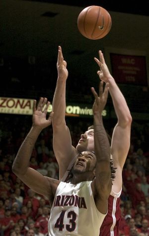 Arizona’s Jordan Hill and Washington State’s Aron Baynes battle for a rebound in the second half.  (Associated Press / The Spokesman-Review)