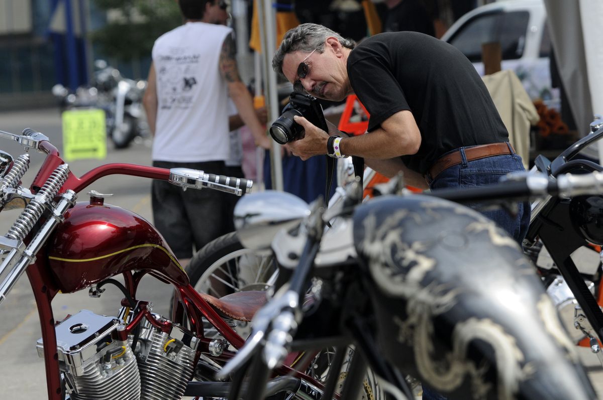 jesset@spokesman.com Dave Dougherty, of Walla Walla, takes photos of custom choppers built by Zacky’s Custom Rods of Seattle  at the 100 Years of Motorcycles show Friday at the Spokane County Fair and Expo Center. (Jesse Tinsley / The Spokesman-Review)