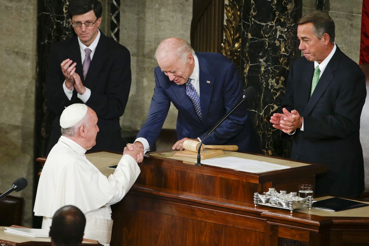 In this Sept. 24, 2015 photo, Vice President Joe Biden shakes hands with Pope Francis on Capitol Hill in Washington, prior to the pope