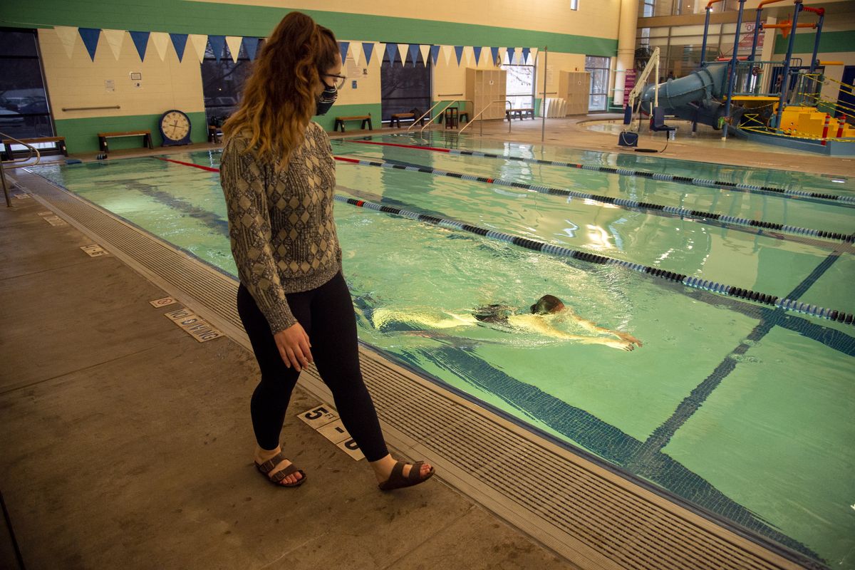 Swim team coach Allarae Prigan, left, watches swimmer Madelyn Demke, 13, perform various practice routines in the pool at the Central Spokane YMCA aquatics center, Thursday, Dec. 17, 2020, the day the Inland Northwest YMCA received a significant donation from MacKenzie Scott, former wife of billionaire Jeff Bezos, part of a $4 billion gift made to 384 different organizations. (Jesse Tinsley/THE SPOKESMAN-REVI)