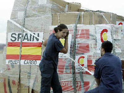 Military personnel secure part of a cargo of 16 tons of humanitarian aid being sent to help victims of Hurricane Katrina before being loaded onto a plane at the Torrejon military air base in Madrid on Wednesday. 
 (Associated Press / The Spokesman-Review)