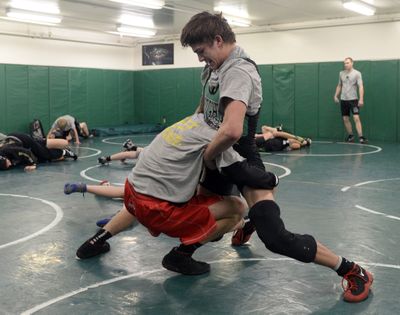 East Valley High School wrestler Trey Meyer, right, fends off his older brother Gabe, during practice at East Valley High Tuesday. Trey wrestles at 145 pounds an Gabe is usually at 138. (Jesse Tinsley)
