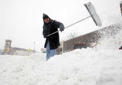 
Joshua Crowe, 28, uses a push broom to get his car out of the snow Saturday in Wichita, Kan. Associated Press
 (Associated Press / The Spokesman-Review)