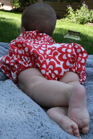 Baby Bristol models a romper made with Amy Butler fabric from The Top Stitch fabric store on Spokane's Near North Side. (Megan Cooley / The Spokesman-Review)