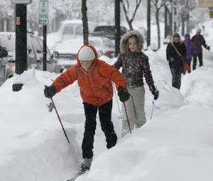 In this Dec. 18, 2008, SR file photo, Emma Burke, 12, and Jessica Fortis, 13, ski down the sidewalks on Sherman Avenue in Coeur d'Alene, as snow continued to fall from the massive snowstorm that blanked the region. Though it was only eight days until Christmas, few shoppers braved the conditions in downtown. (Jesse Tinsley/SR file photo)
