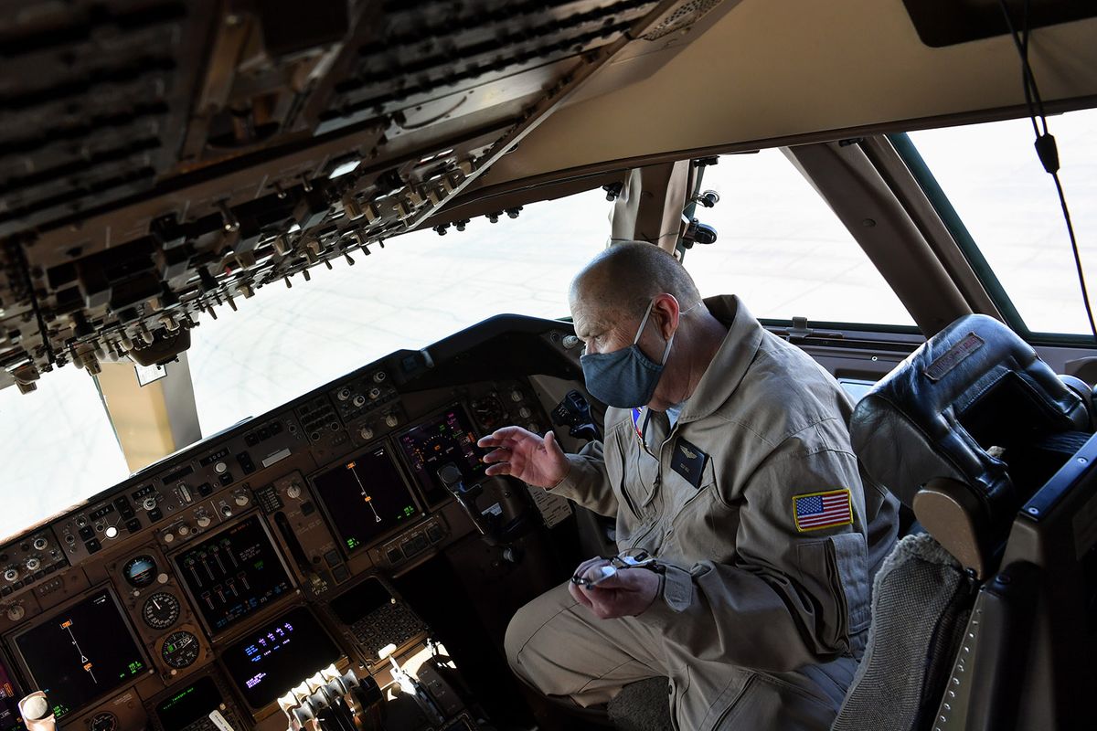Capt. Cliff Hale, chief pilot of a Global Supertanker, sits in the aircraft’s cockpit Tuesday as he speaks to the media during during a wildfire response demonstration hosted by AreoTEC at Grant County International Airport in Moses Lake.  (Tyler Tjomsland/The Spokesman-Review)