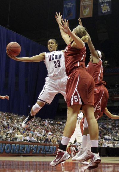 Connecticut’s Maya Moore shoots over Stanford’s Joslyn Tinkle, front, in the women’s NCAA title game. (Associated Press)