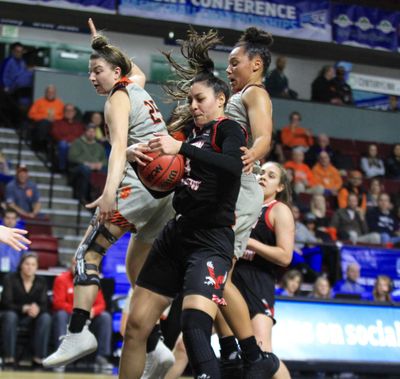 Eastern Washington forward Bella Cravens, center, fights for a rebound between two Idaho State defenders Tuesday at CenturyLink Arena in Boise. The Eagles upset the Bengals 67-65 in the Big Sky Conference Tournament quarterfinals. (Skyline Sports / Courtesy)