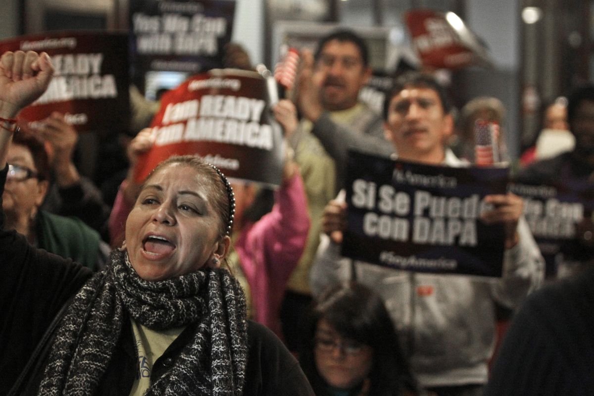 Mercedes Herrera and others chant during an event on DACA and DAPA Immigration Relief at the Houston International Trade Center in Houston on Feb. 17, 2015.  (Melissa Phillip)