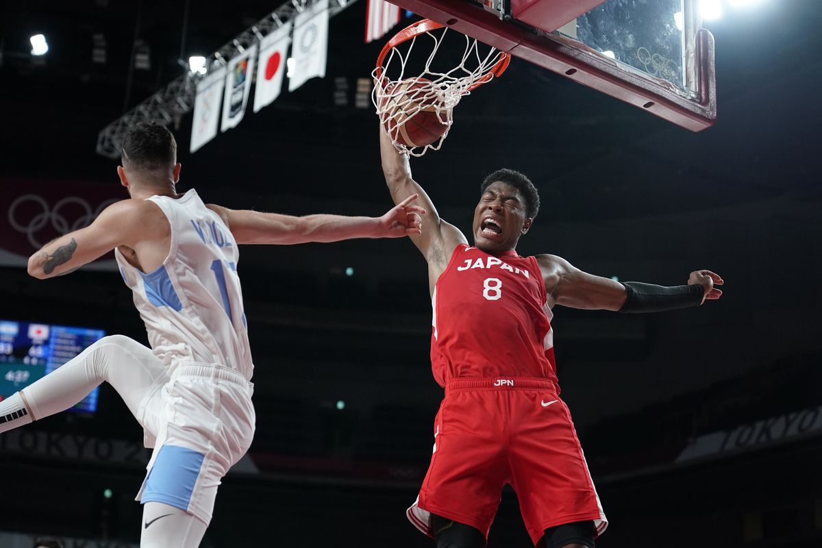Japan’s Rui Hachimura (8) dunks over Argentina’s Luca Vildoza (17) during men’s basketball preliminary round game at the 2020 Summer Olympics, Sunday, Aug. 1, 2021, in Saitama, Japan.  (Associated Press)
