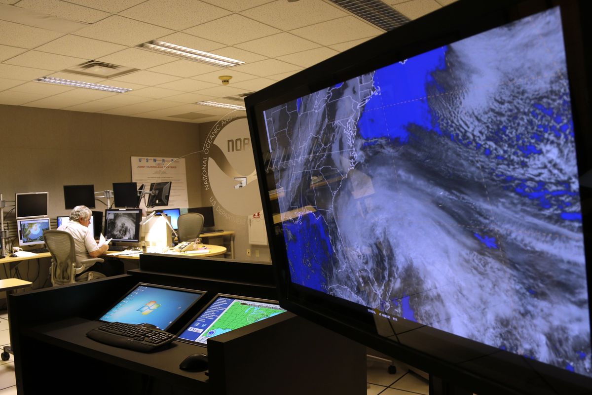 A satellite image of Hurricane Sandy is shown on a computer screen at the National Hurricane Center in Miami on Friday, Oct. 26, 2012. Sandy left 21 people dead as it moved through the Caribbean, following a path that could see it blend with a winter storm and reach the U.S. East Coast as a super-storm next week. (Lynne Sladky / Associated Press)