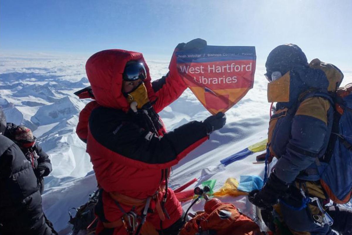 In this May 2017 photo provided by Lhakpa Sherpa, Sherpa displays a flag from West Hartford, Conn., on the summit of Mount Everest in Nepal. Once a year, Sherpa heads back to her native Nepal to try and break her own record for successful summits of Mount Everest by a woman. (Lhakpa Sherpa / AP)