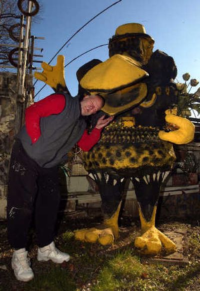 
Richard Tracy sticks his head in the beak of his Yard Bird, which stands shielded from public view among his other art at his home in Centralia, Wash., Feb. 15, 2006.
 (AP / The Spokesman-Review)