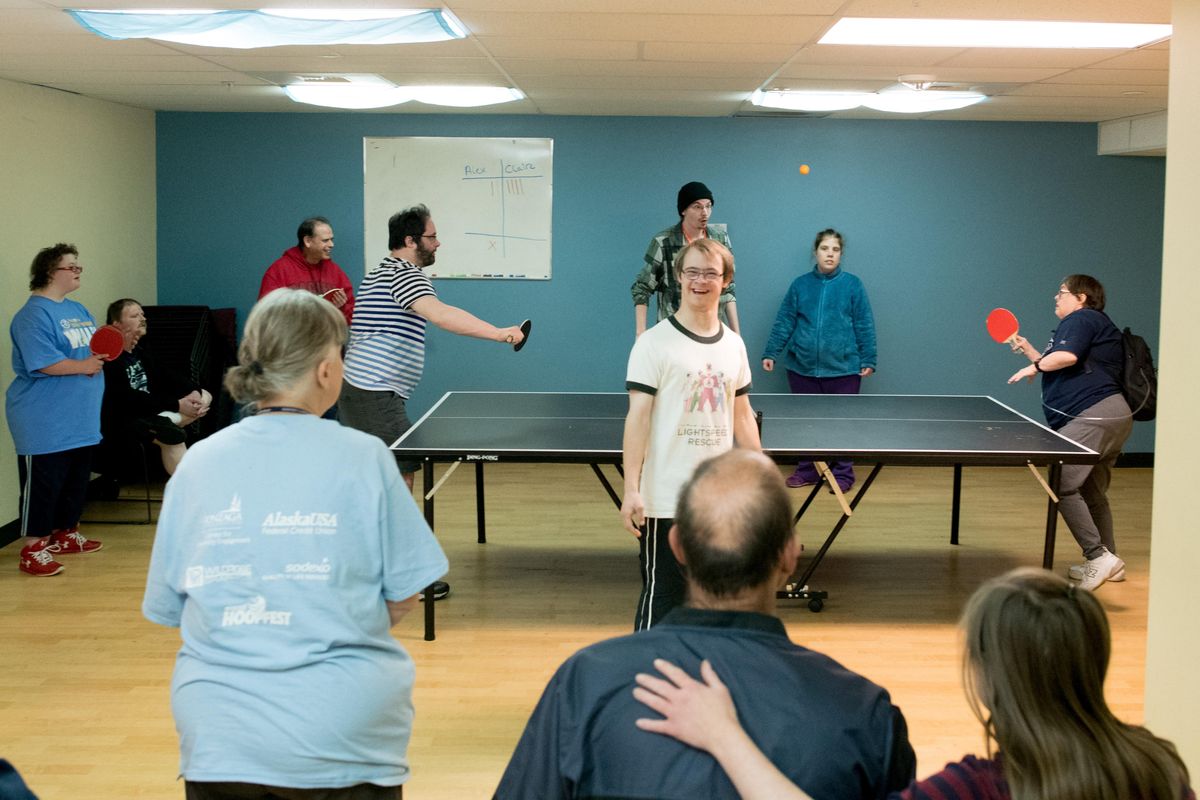 Aaron Dwright, center, smiles as Alex McGarry, left, plays Claire Burdick at pingpong on Wednesday, Oct. 17, 2018, at the ARC of Spokane community center. The Arc is hosting a conference with the national Arc CEO, Peter Berns, on Thursday. (Tyler Tjomsland / The Spokesman-Review)
