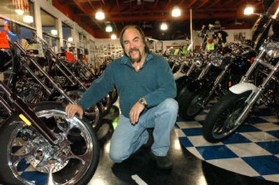 
Scott Lyon, owner of the Easyriders Road House in Post Falls kneels with some of his inventory, everything from road-weary used Harleys to high-dollar chrome choppers. A lot of people come in his shop just to buy leather clothes and accessories, T-shirts and other motorcycle goods because of the popularity of American motorcycles. 
