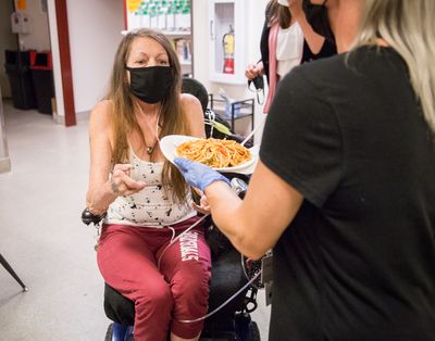 Julie Mowery receives a plate of spaghetti Tuesday at a branch of Hope House on West Eighth Avenue. .  (Libby Kamrowski/ The Spokesman-Review)